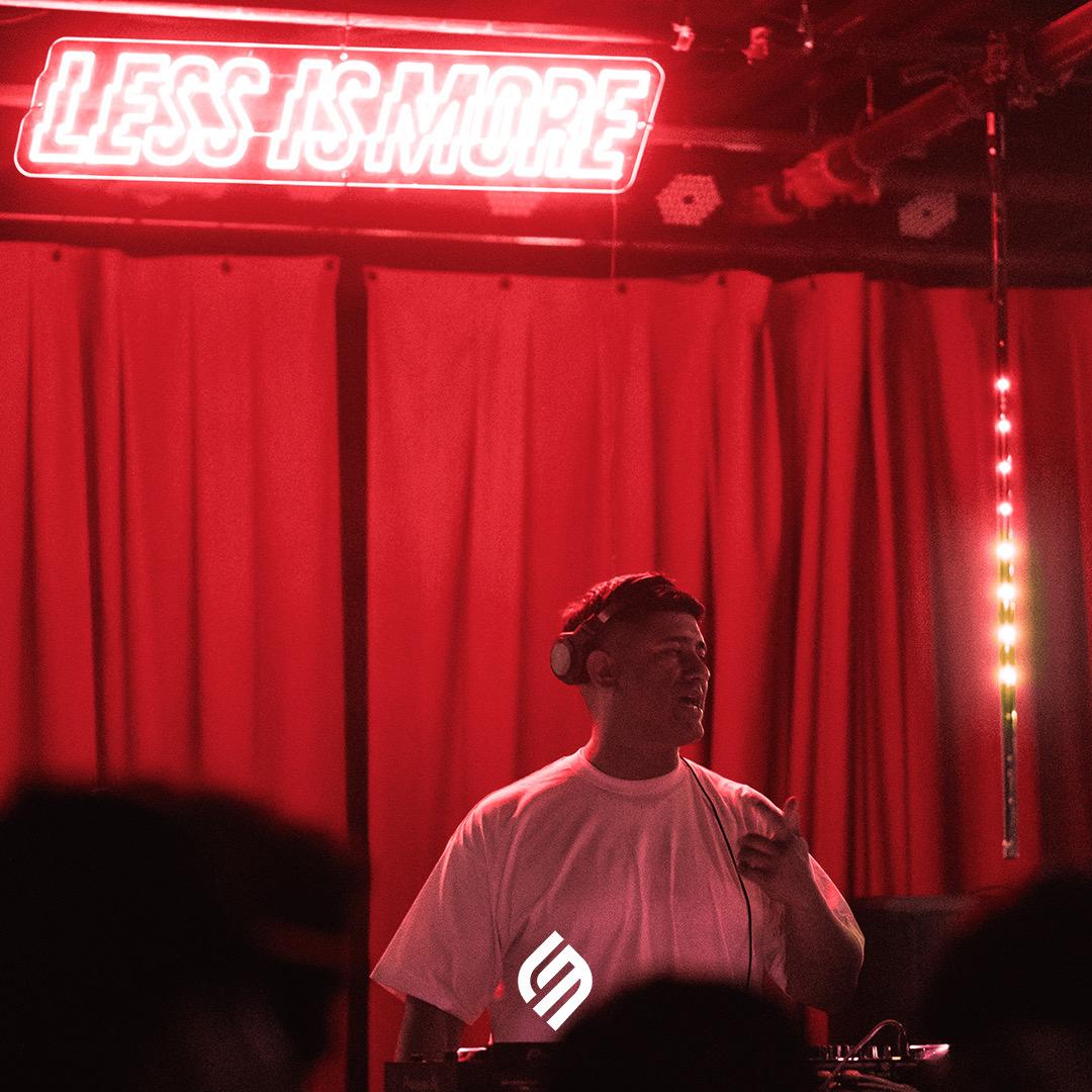 DJ under neon sign